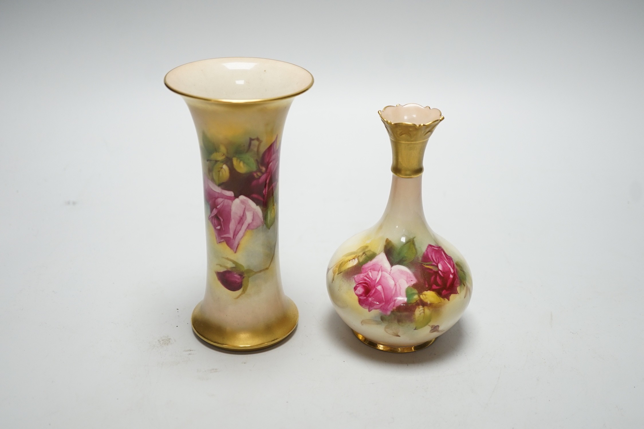 A Royal Worcester trumpet vase, shape G923 painted with roses by M. Hunt, signed, date code 1925 and another vase, shape G702 painted with roses, date code 1924, tallest 16cm